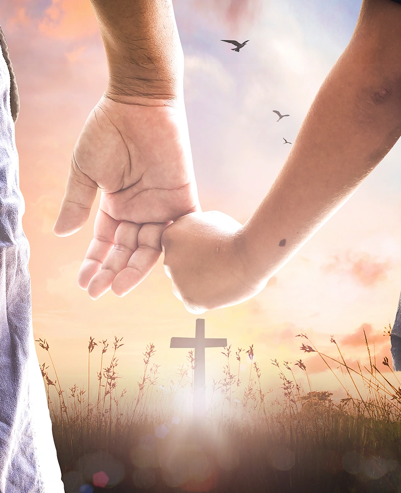 Holding hands, cross in field, sunset background.